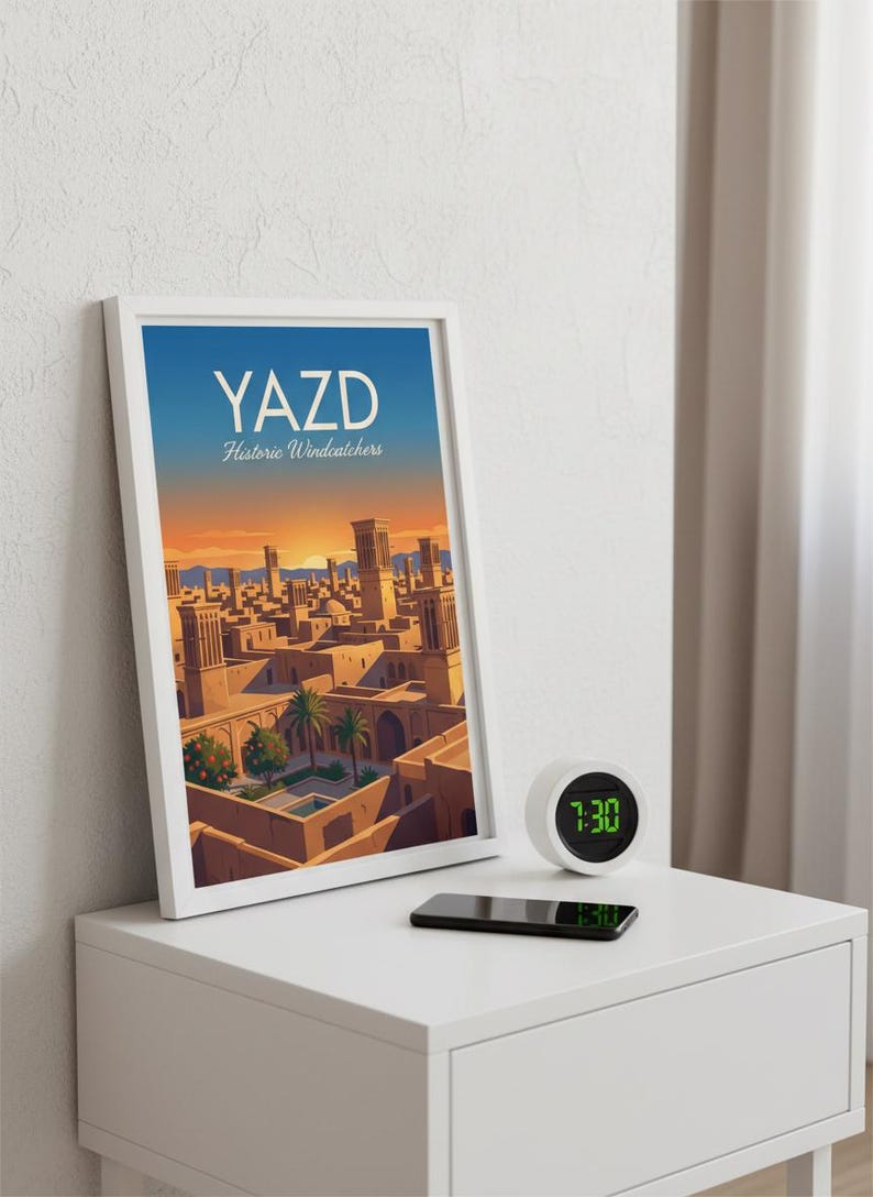 May include: A framed print titled "YAZD Historic Windcatchers" shows a cityscape with traditional architecture under a sunset sky. A small digital clock displays 7:30, and a smartphone rests on a white bedside table.