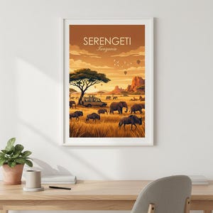 May include: Framed art print featuring a Serengeti landscape with elephants, zebras, and a safari vehicle. The artwork has a warm color palette with the text "SERENGETI Tanzania" at the top. The scene includes hot air balloons and a large tree.