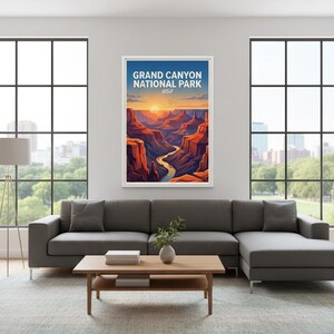 May include: A framed art print of the Grand Canyon National Park in the USA. The artwork depicts a vibrant sunset over the canyon, with the text "GRAND CANYON NATIONAL PARK USA" at the top. The print is displayed in a modern living room setting.