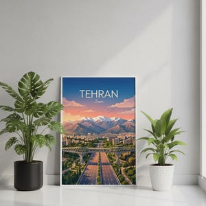 May include: A framed art print featuring a scenic view of Tehran, Iran. The artwork depicts a highway, buildings, and mountains under a blue sky with the text "TEHRAN Iran". Two potted plants flank the artwork.