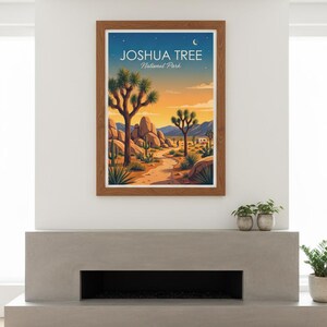May include: Framed art print featuring a desert landscape with Joshua trees, rocks, and a path. The artwork has a warm color palette of orange, blue, and brown. The text "JOSHUA TREE National Park" is displayed at the top.