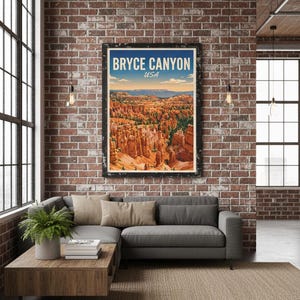 May include: A framed poster with the text "BRYCE CANYON USA" hangs on a brick wall above a gray sectional sofa. The poster depicts a landscape of orange rock formations under a blue sky. A wooden coffee table and a jute rug complete the living room setting.