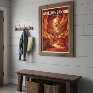 May include: A framed poster of Antelope Canyon, Arizona, hangs on a white paneled wall. Below, a dark wooden bench with two woven baskets sits on a stone floor. A denim jacket and tote bag hang on hooks.