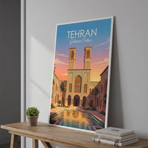 May include: A framed art print featuring a stylized illustration of the Golestan Palace in Tehran, Iran. The artwork depicts the palace with its distinctive architecture, a reflecting pool, and the text "TEHRAN Golestan Palace" at the top.