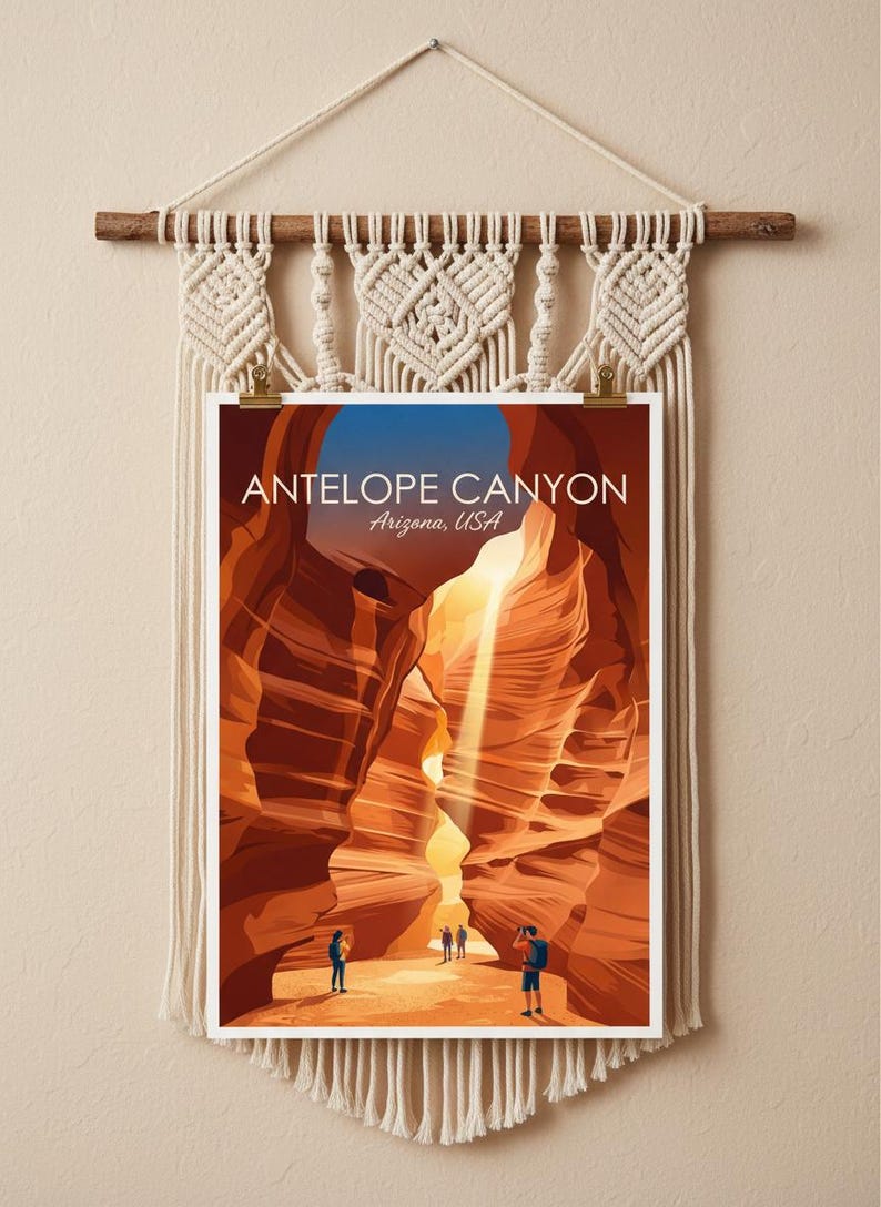 May include: A rectangular print of Antelope Canyon, Arizona, USA, featuring orange sandstone walls and a light beam, suspended from a cream-colored macrame wall hanging with a wooden dowel and fringe. The print displays the text Antelope Canyon Arizona, USA.