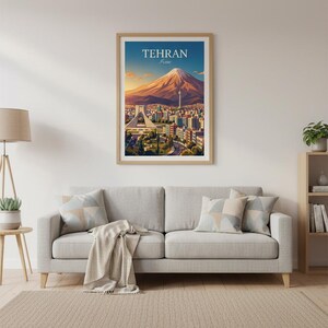 May include: A framed art print featuring a stylized illustration of Tehran, Iran. The artwork depicts a mountain, city buildings, and the text "TEHRAN" in a blue sky. The print is displayed above a gray sofa with decorative pillows.