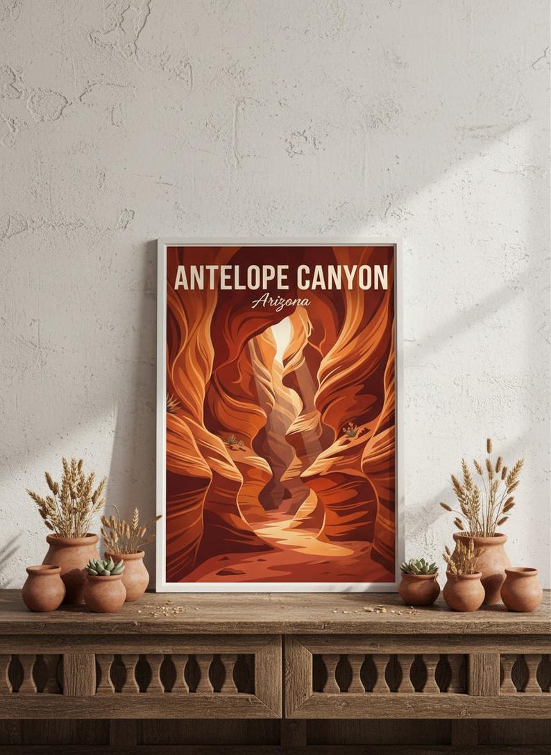 May include: A framed art print featuring Antelope Canyon in Arizona. The artwork depicts the canyon's sandstone walls in shades of orange and brown, with the text "ANTELOPE CANYON Arizona" at the top. The print is displayed on a wooden cabinet with terracotta pots.