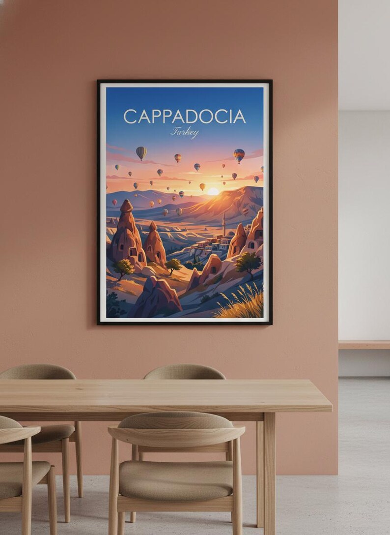 May include: A framed art print featuring a vibrant landscape of Cappadocia, Turkey, with hot air balloons floating in a sunset sky. The print includes the text "Cappadocia Turkey". The artwork depicts unique rock formations and a village.