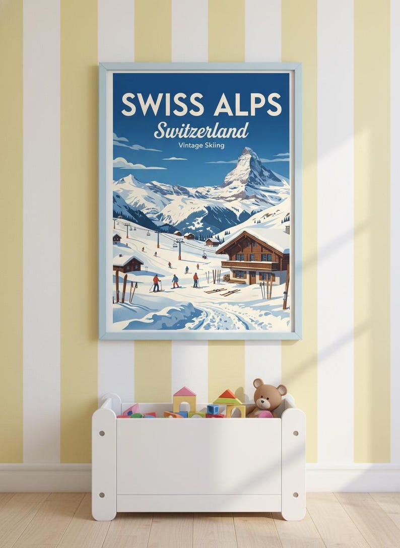 May include: A framed vintage poster of the Swiss Alps, featuring a snowy mountain landscape with skiers and chalets. The poster has a light blue frame and the text "SWISS ALPS Switzerland Vintage Skiing". Below, a white toy chest is filled with toys.