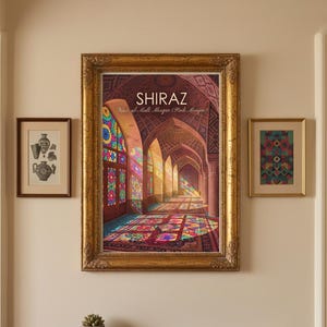 May include: A large, ornate gold-framed print of the Nasir al-Mulk Mosque in Shiraz, featuring colourful stained glass light patterns on the floor. It is flanked by two smaller framed prints and sits above a dark wood console table.