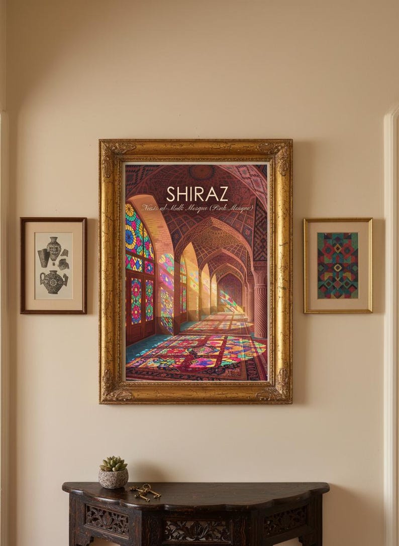 May include: A large, ornate gold-framed print of the Nasir al-Mulk Mosque in Shiraz, featuring colourful stained glass light patterns on the floor. It is flanked by two smaller framed prints and sits above a dark wood console table.