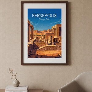 May include: Framed art print featuring a stylized illustration of Persepolis in Shiraz, Iran. The artwork depicts ancient ruins with columns, arches, and figures, set against a blue sky and desert landscape. The print is in a dark brown frame.