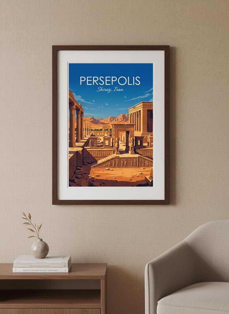 May include: Framed art print featuring a stylized illustration of Persepolis in Shiraz, Iran. The artwork depicts ancient ruins with columns, arches, and figures, set against a blue sky and desert landscape. The print is in a dark brown frame.