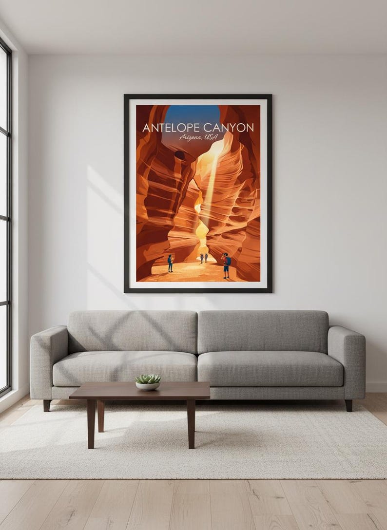 May include: A framed poster featuring Antelope Canyon in Arizona, USA. The artwork depicts the canyon's sandstone walls in shades of orange and brown, with sunlight streaming through. Several figures are visible at the canyon's base. The poster is displayed above a gray sofa.