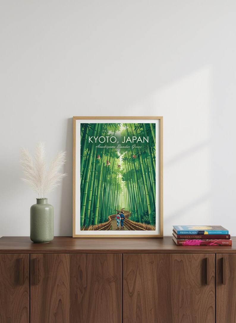 May include: Framed art print featuring a vibrant illustration of the Arashiyama Bamboo Grove in Kyoto, Japan. The artwork depicts a path winding through towering green bamboo stalks, with the text "KYOTO, JAPAN" at the top.