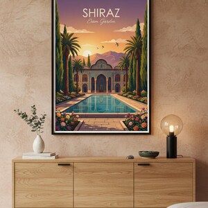 May include: A framed art print depicting the Eram Garden in Shiraz, Iran. The artwork showcases a serene pool, a detailed building, palm trees, and a sunset. The text "SHIRAZ Eram Garden" is displayed at the top.