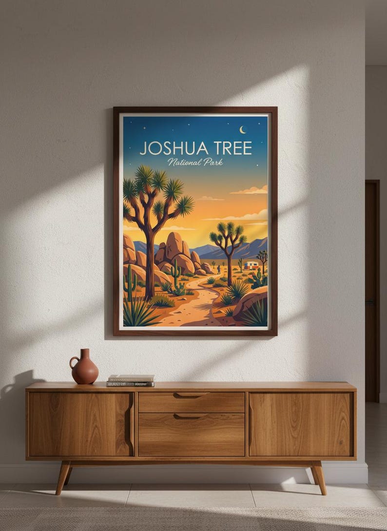 May include: A framed art print featuring a desert landscape with Joshua trees, cacti, and a path leading to the horizon. The artwork has a warm color palette of oranges, blues, and yellows, with the text "JOSHUA TREE National Park" at the top.
