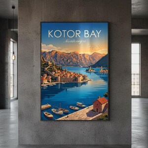 May include: A framed art print of Kotor Bay, Montenegro. The artwork depicts a coastal town with buildings, boats, and mountains under a blue sky. The text "KOTOR BAY Montenegro" is at the top of the print.