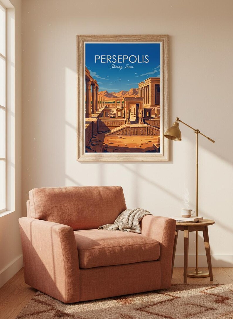 May include: A framed art print of Persepolis, Shiraz, Iran, hangs above a coral-colored armchair. The print depicts an ancient city with columns and structures under a blue sky. A small side table and lamp are next to the chair.