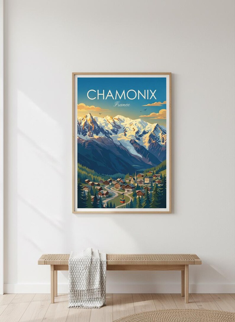 May include: Framed art print of Chamonix, France, depicting a mountain landscape with snow-capped peaks, a village in a valley, and the text "CHAMONIX France" against a blue sky.