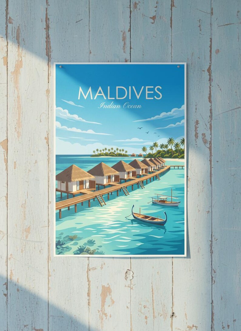 May include: A poster featuring a scenic view of the Maldives. The image shows several bungalows on stilts over turquoise water, with boats and palm trees. The sky is a bright blue with the text "MALDIVES Indian Ocean".