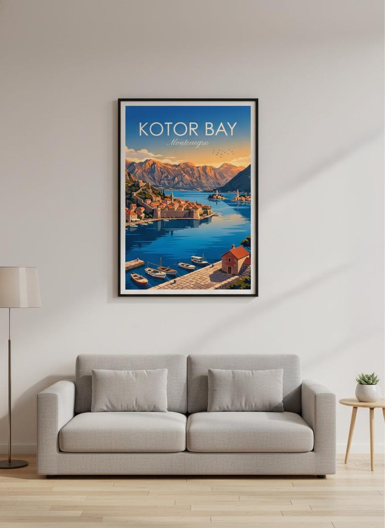 May include: Framed art print of Kotor Bay, Montenegro. The artwork depicts a coastal town with boats on the water, surrounded by mountains. The sky transitions from orange to blue. The text "KOTOR BAY Montenegro" is at the top.