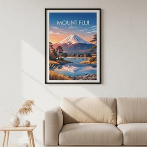 May include: Framed art print featuring Mount Fuji in Japan. The artwork depicts the iconic mountain with a snow-capped peak, reflected in a serene lake. The sky transitions from blue to orange, with the text "MOUNT FUJI Japan" at the top.