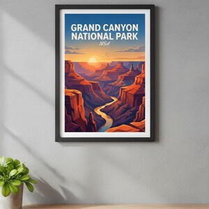 May include: Framed art print featuring a stylized illustration of the Grand Canyon at sunset. The artwork displays the canyon's layered rock formations, a winding river, and the text "GRAND CANYON NATIONAL PARK USA" in white against a blue sky.