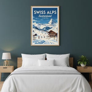 May include: A framed vintage poster of the Swiss Alps in Switzerland, featuring a snowy mountain range and skiers. The poster has a blue sky and a wooden chalet. The text on the poster reads "SWISS ALPS Switzerland Vintage Skiing."