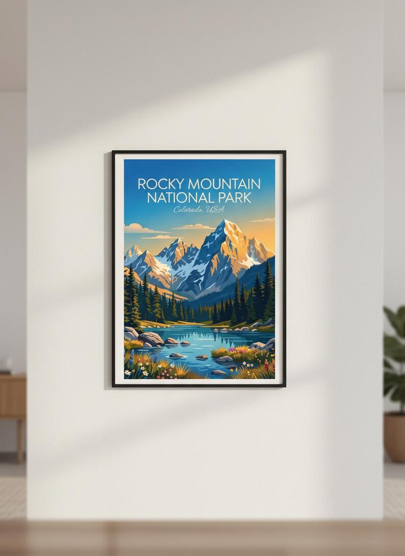 May include: A framed art print showcasing a landscape of the Rocky Mountain National Park in Colorado, USA. The image presents a mountain range, a lake, and evergreen trees under a blue sky. The text "Rocky Mountain National Park" is displayed at the top.