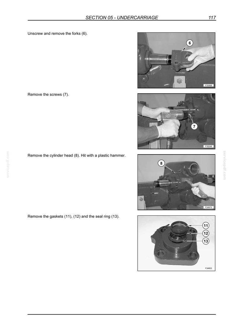 May include: A technical manual page titled SECTION 05 - UNDERCARRIAGE, page 117, featuring four black and white instructional photographs. The images demonstrate the removal of forks, screws, a cylinder head using a hammer, and gaskets 11, 12, and seal ring 13.