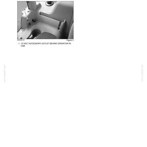 May include: A grayscale image from a manual showing an interior vehicle component. The image highlights a 12-volt accessory outlet located behind the seat, on the right-hand side of the machine. The text reads "ACCESSORY OUTLETS" and "12 VOLT ACCESSORY OUTLET BEHIND OPERATOR IN CAB."