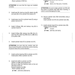 May include: Technical diagram detailing the assembly of boom cylinders, including installation steps for bushings, seals, and rings. Measurements are provided in inches and foot-pounds.