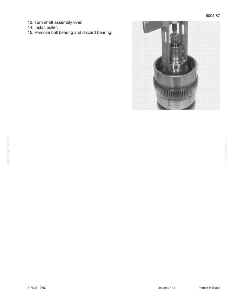 May include: An exploded view of a mechanical assembly, with a detailed close-up of a cylindrical component. The image includes text instructions: "Turn shaft assembly over," "Install puller," and "Remove ball bearing and discard bearing."