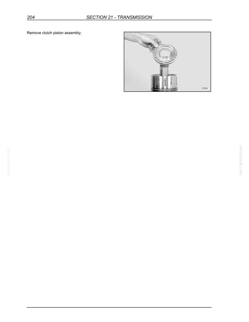 K&ouml;nnte beinhalten: Diagramm einer Getriebekomponentenbaugruppe. Das Bild zeigt eine Hand, die ein kreisf&ouml;rmiges Teil &uuml;ber einer zylindrischen Komponente h&auml;lt. Der Text oben lautet "SECTION 21 - TRANSMISSION".