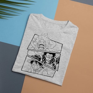 May include: A light gray t-shirt featuring a black and white graphic of three anime character panels. The top panel shows a character with spiky hair, the middle panel shows a character with a hat, and the bottom panel shows a character with an angry expression.