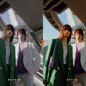 May include: Two people wearing stylish outerwear stand outdoors. One wears a green blazer with a pink top and a purple purse. The other wears a white blazer over a purple shirt. The background features a modern architectural structure.