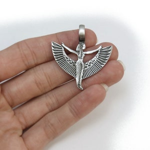 May include: Silver pendant featuring a detailed depiction of the Egyptian goddess Isis with outstretched wings.