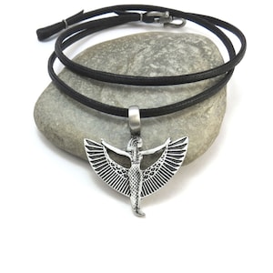 May include: A silver pendant necklace with a winged goddess design on a black leather cord.