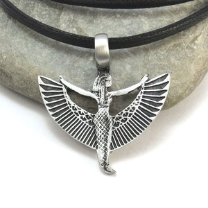 May include: Silver pendant necklace featuring a winged goddess with outstretched arms. The pendant is on a black cord.
