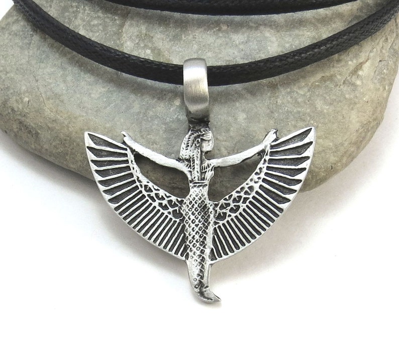 May include: Silver pendant necklace featuring a winged goddess with outstretched arms. The pendant is on a black cord.