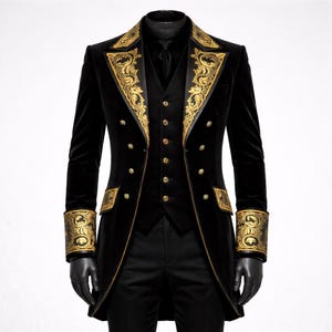 May include: Black velvet formal suit with gold embroidered accents. The suit includes a long coat, vest, and trousers. The coat features ornate gold embroidery on the lapels, cuffs, and pockets, with gold buttons. The suit is a classic formal wear.