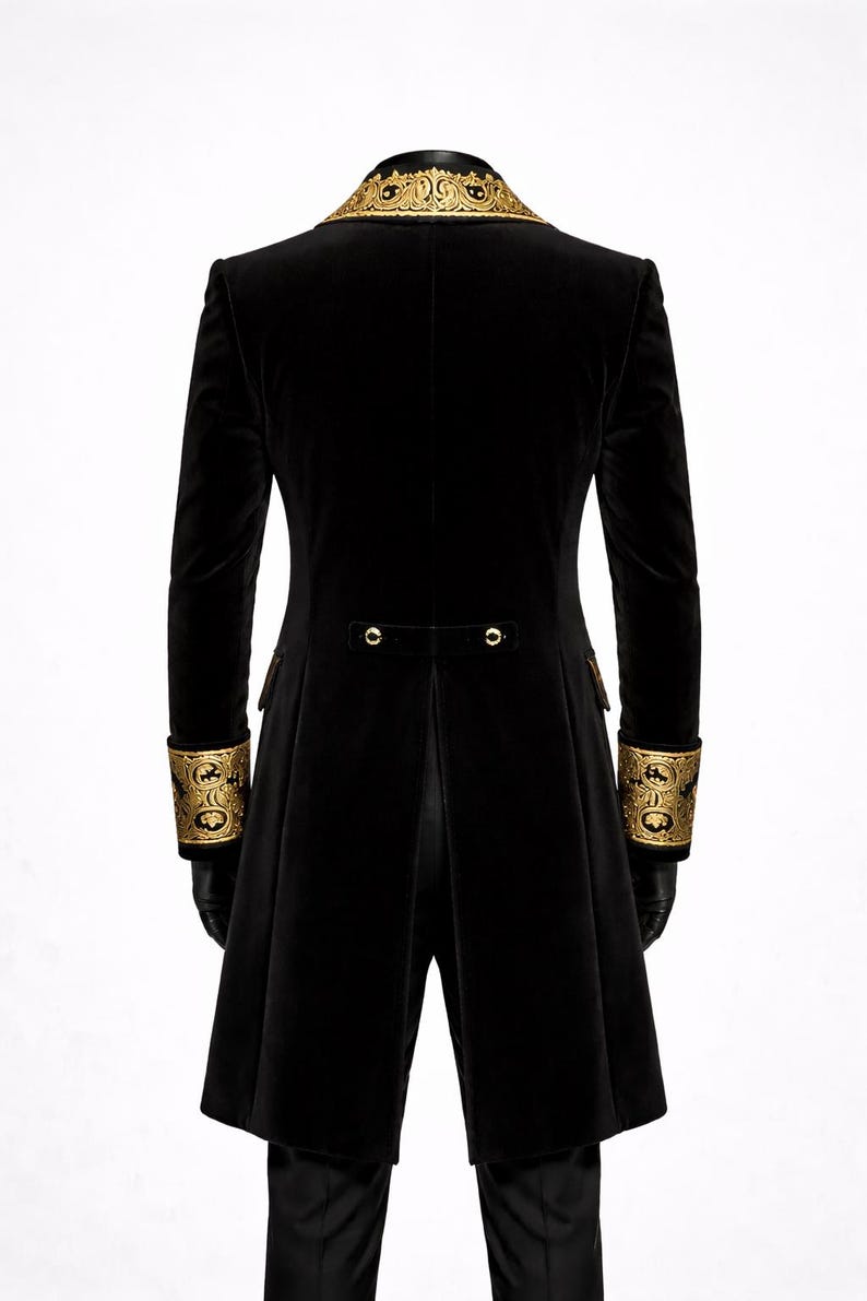 May include: Black velvet coat with gold embroidered collar and cuffs. The long coat features a tailored fit, with gold button details on the back and cuffs. The sleeves are long and fitted. The coat is a formal style.