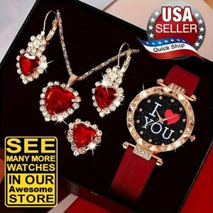 May include: A jewelry set featuring a gold-tone necklace, a pair of earrings, and a ring, each with a red heart-shaped stone surrounded by clear crystals. A gold-tone watch with a red strap and a black dial displaying the text I LOVE YOU.