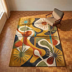 May include: A rectangular area rug featuring a multi-colored abstract pattern with flowing organic shapes, dark blue lines, and sunburst motifs in shades of mustard yellow, burnt orange, olive green, and teal, set on a wooden floor.