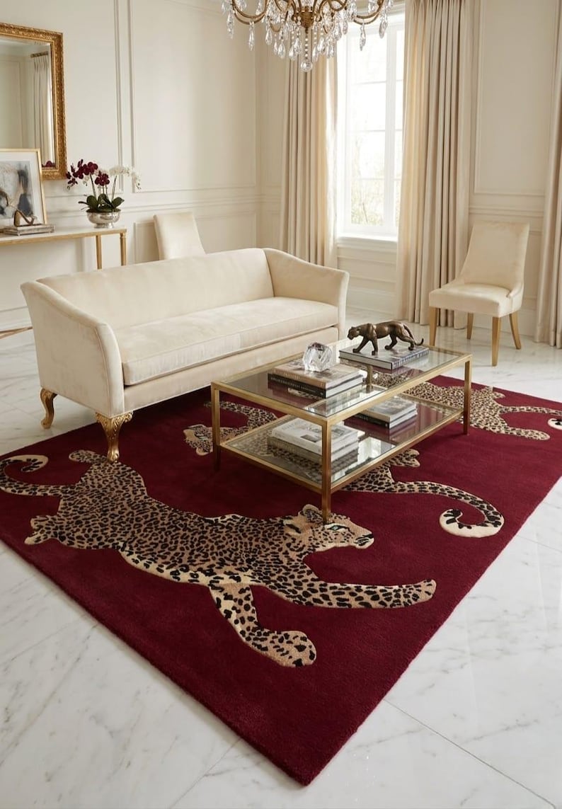 May include: A rectangular area rug featuring a deep burgundy background with multiple repeating leopard motifs in shades of tan, brown, and black. The rug is positioned on a white marble floor, showcasing a large-scale animal print pattern.