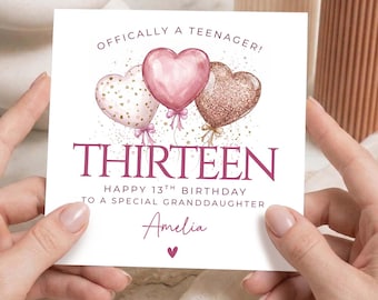 May include: A white birthday card with the text "OFFICIALLY A TEENAGER!" and "THIRTEEN". The card features three heart-shaped balloons in pink and gold glitter. The card reads "HAPPY 13TH BIRTHDAY TO A SPECIAL GRANDDAUGHTER" and has the name "Amelia" written on it.
