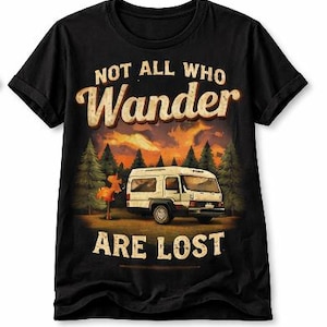May include: Black t-shirt with a graphic of a camper van in a forest scene under a sunset. The text reads "NOT ALL WHO WANDER ARE LOST" in a vintage style font.