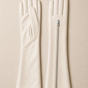 Elegant ivory long leather gloves handcrafted from premium soft Nappa leather with a full-length silver zipper. Luxury opera-length women's gloves featuring a full-finger design, perfect for bridal wear, formal occasions, evening fashion, driving, vintage style, and winter elegance.