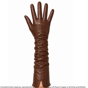 Brown long leather opera glove for women featuring ruched detailing, a raised center seam line, full fingers, and a small cuff slit.